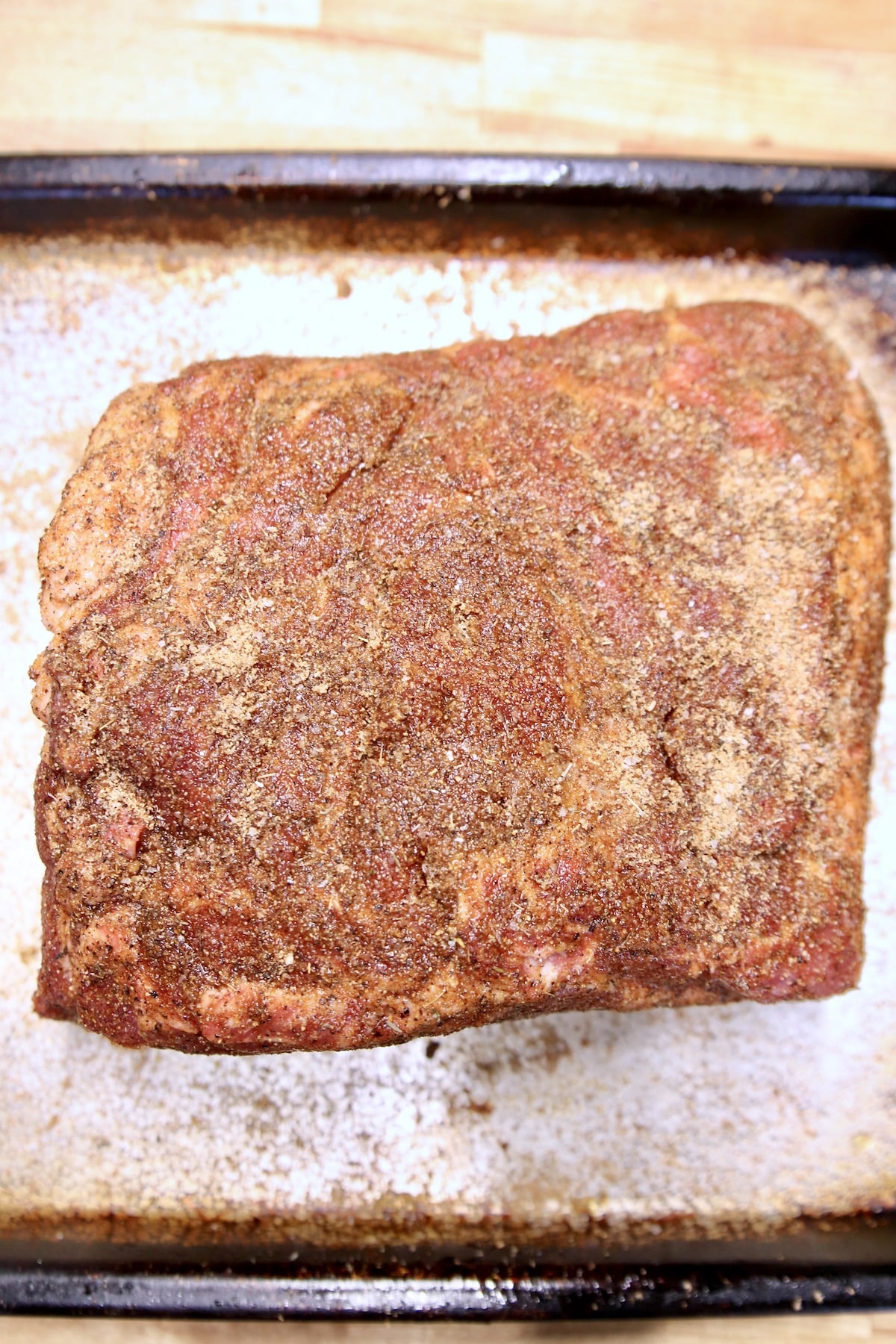 Seasoned pork butt ready to grill.
