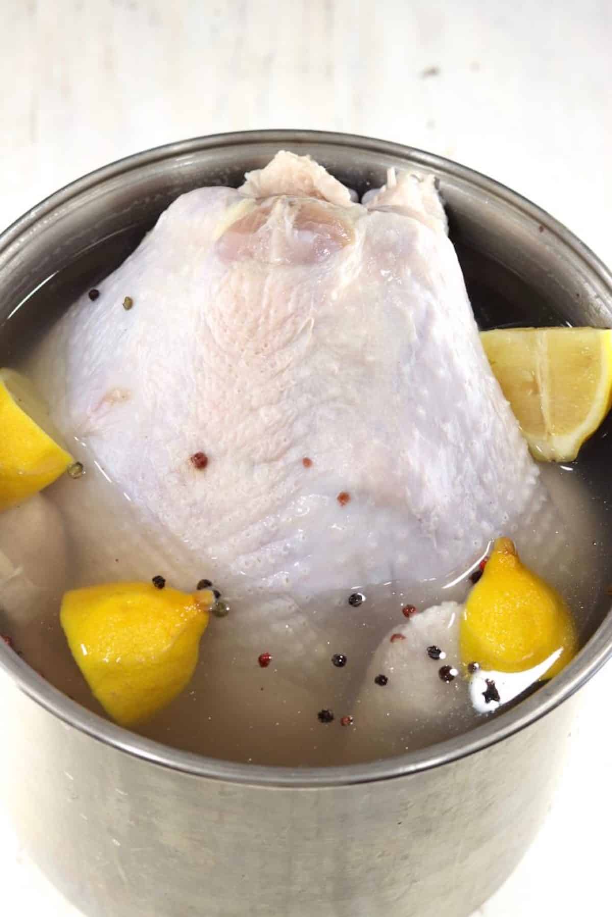 Brining a turkey with lemons and peppercorns.