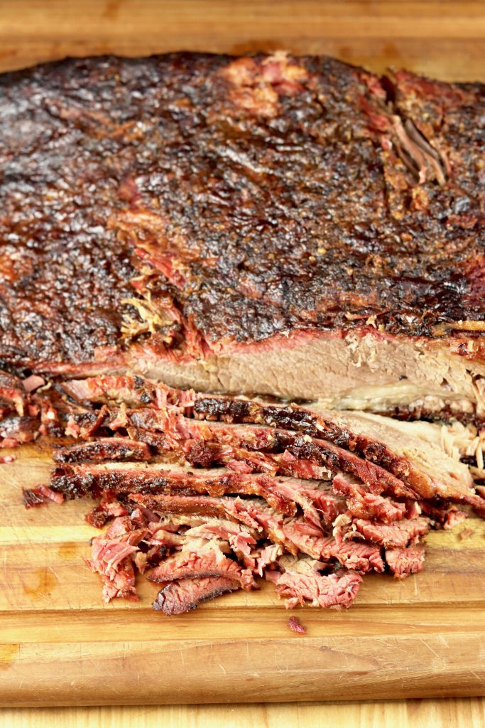 Smoked Brisket is the holy grail of all grilled meats. This recipe includes a sweet garlic rub that creates a delicious crust for your tender and juicy brisket. 