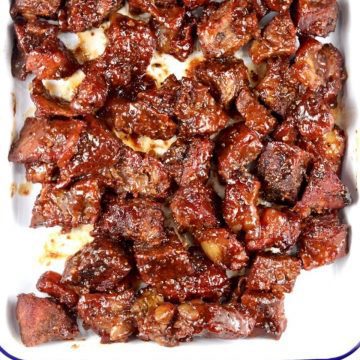 Poor Man's Burnt Ends with bbq sauce on a baking pan
