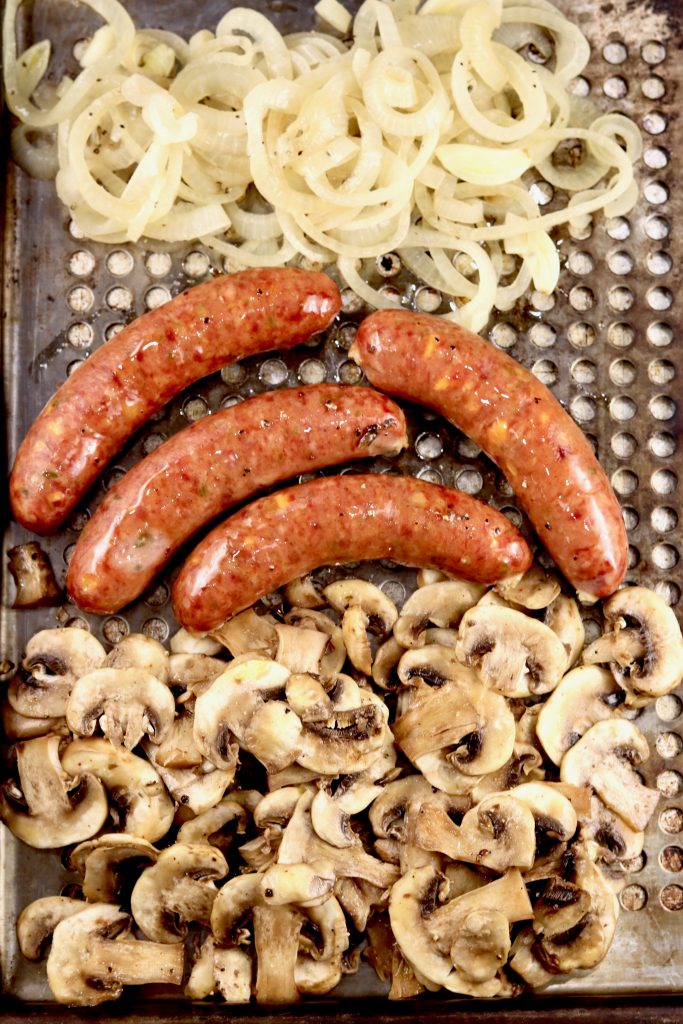 Onions, Bratwurst and Mushrooms on a grill pan