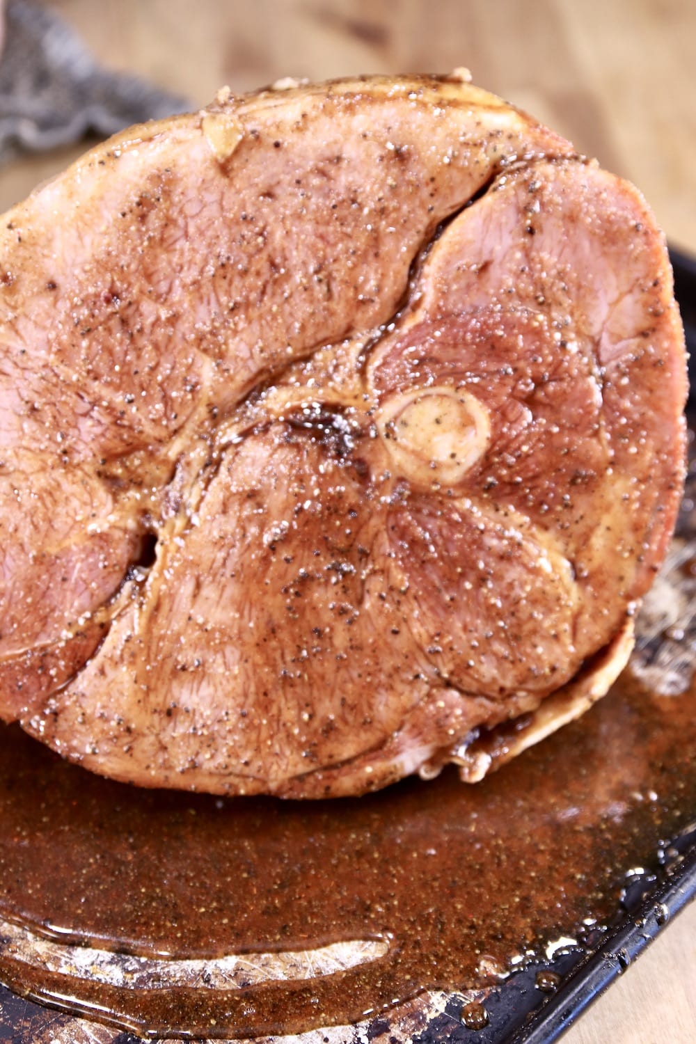 Half ham on a sheet pan with maple glaze