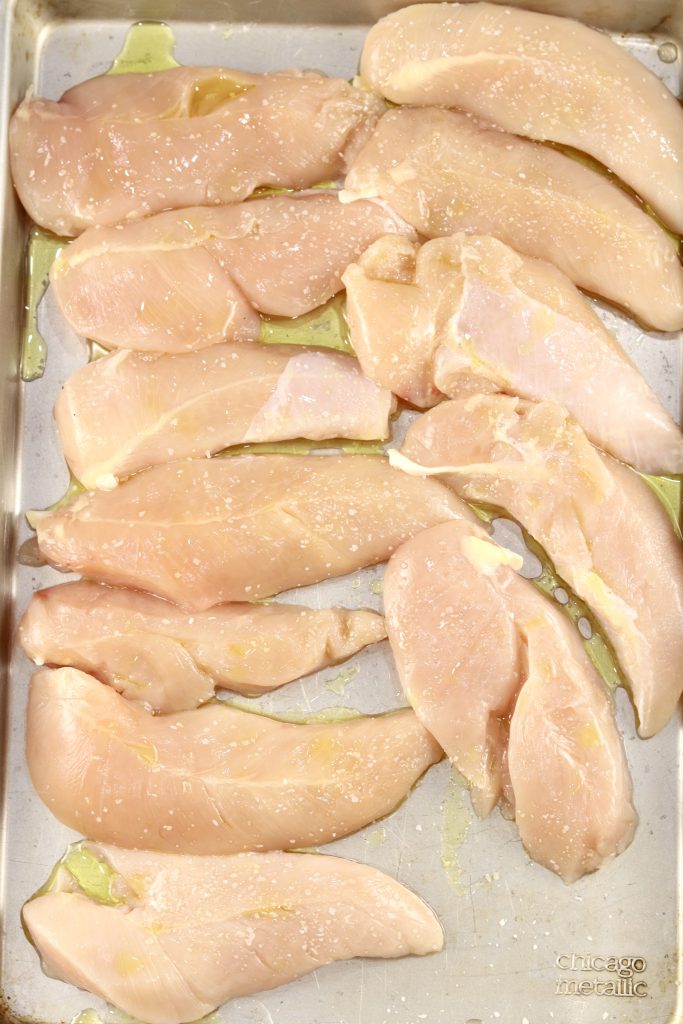 Chicken tenders with olive oil and salt on a sheet pan