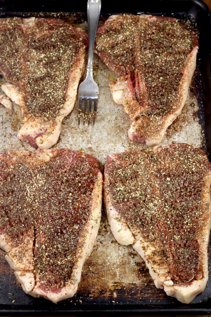 Dry Rubbed T-Bone Steaks on a sheet pan