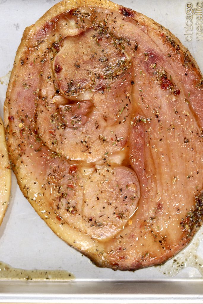 Grilled Ham Steak on a baking sheet with brown sugar glaze