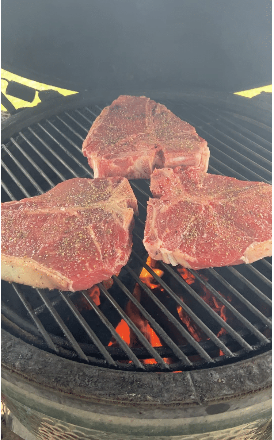 T-Bone Steaks on a grill.