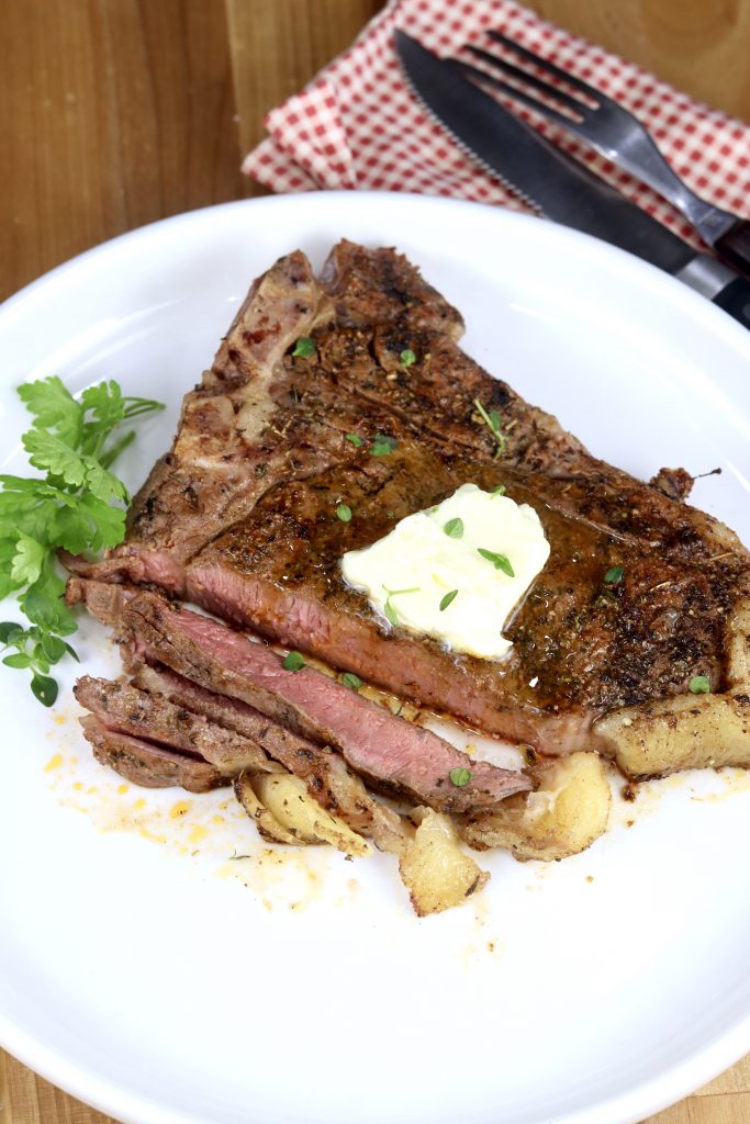Grilled T-Bone Steak sliced with a pat of butter