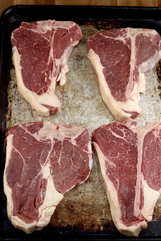 T-Bone Steaks on a sheet pan for grilling