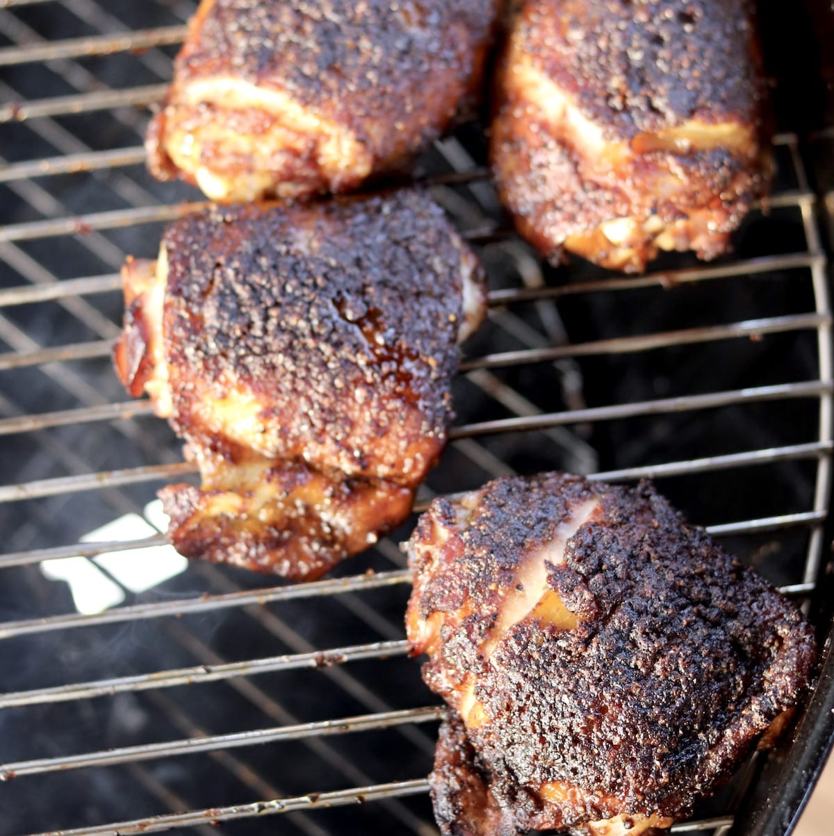 Brown Sugar Smoked Chicken Thighs on the grillBrown Sugar Smoked Chicken Thighs are incredibly delicious and easy to prepare in your own back yard. A quick brine keeps this chicken moist and juicy and the brown sugar and garlic rub adds amazing flavor to the smoked chicken. 