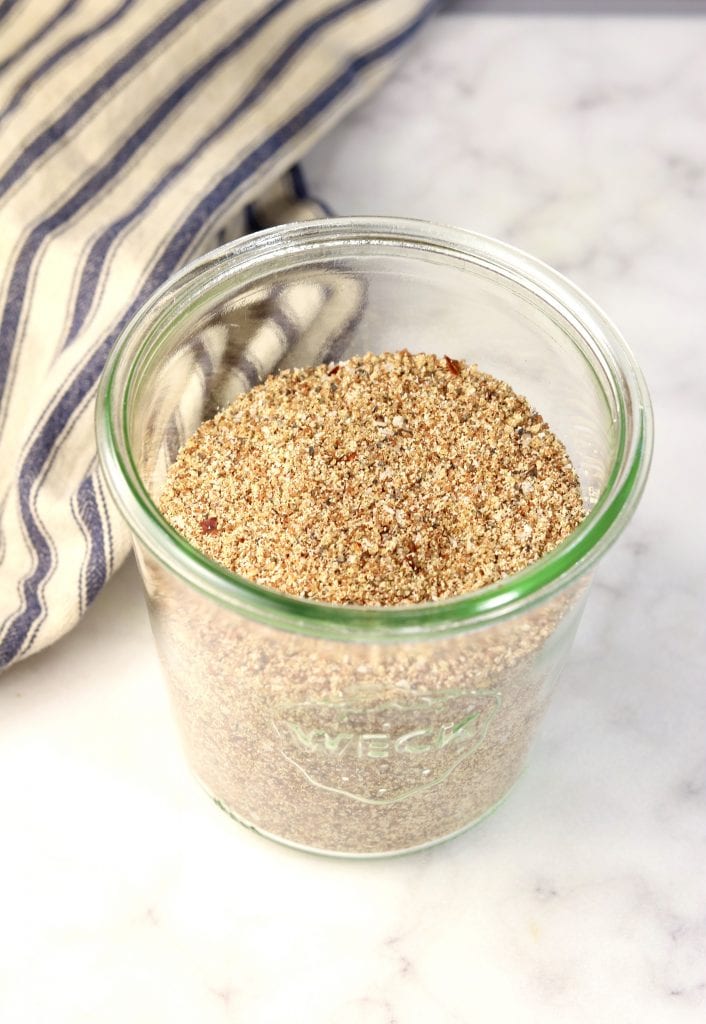 Brown Sugar and spice rub for grilling in a jar with a blue striped towel