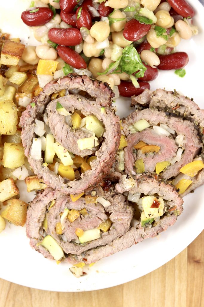 Steak pinwheels with bean salad on a plate