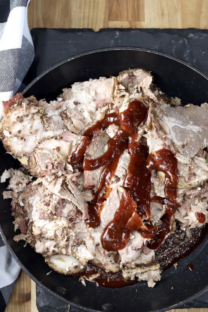 Brisket in a pan with bbq sauce