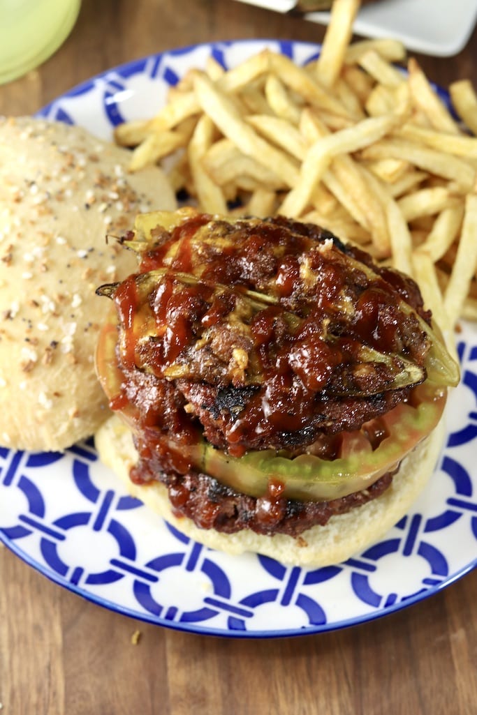 Grilled burgers with stuffed peppers on top