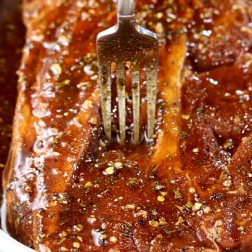 Fork in a marinating beef roast.