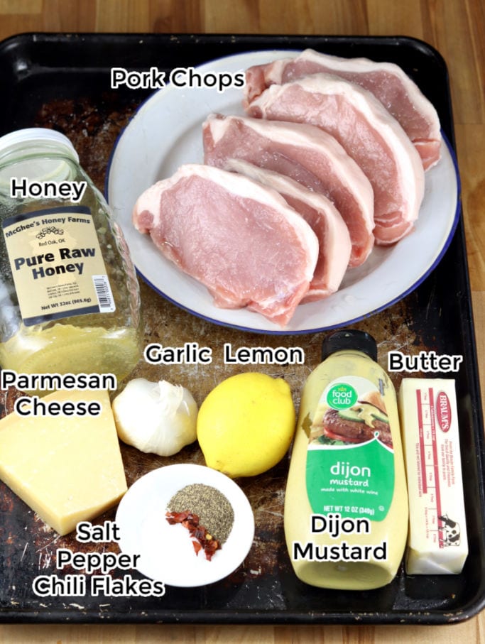 Ingredients for Grilled Pork Chops with lemon garlic sauce: honey, butter, lemon, garlic, dijon mustard, Parmesan cheese, salt, pepper, chili flakes