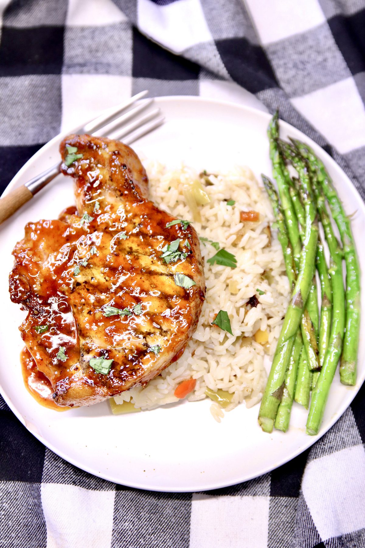 plate of peach bbq sauce with rice and asparagus.