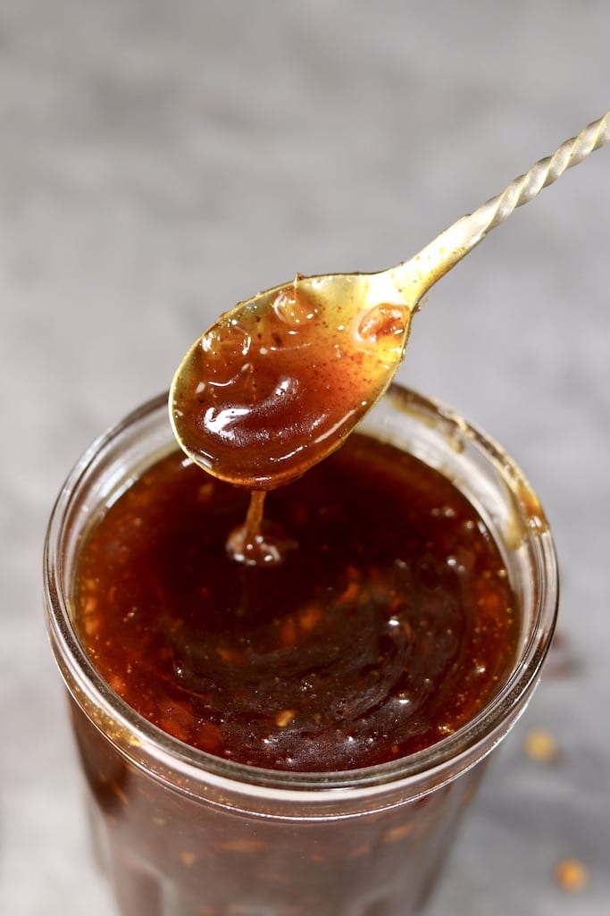 Jar of peach bbq sauce - with spoon dipping