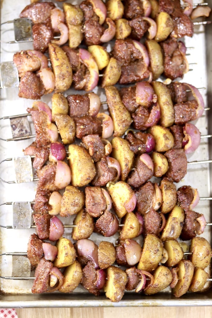 Steak and potato kabobs on a sheet pan ready to grill