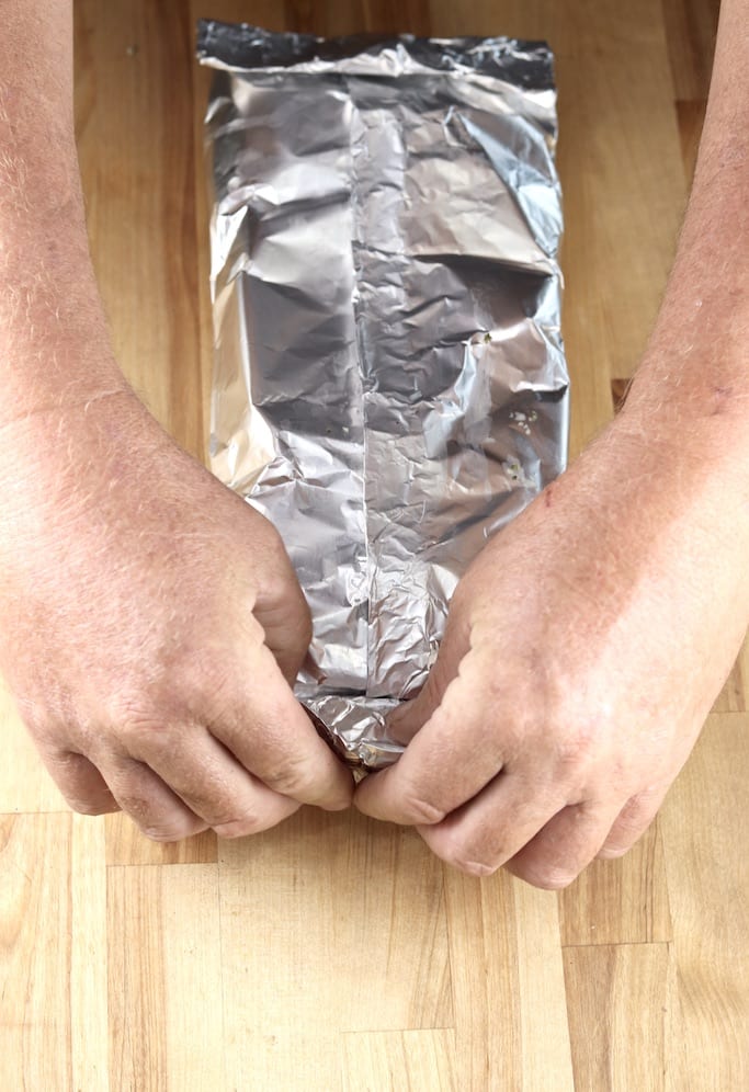 Sealing a foil packet of potatoes