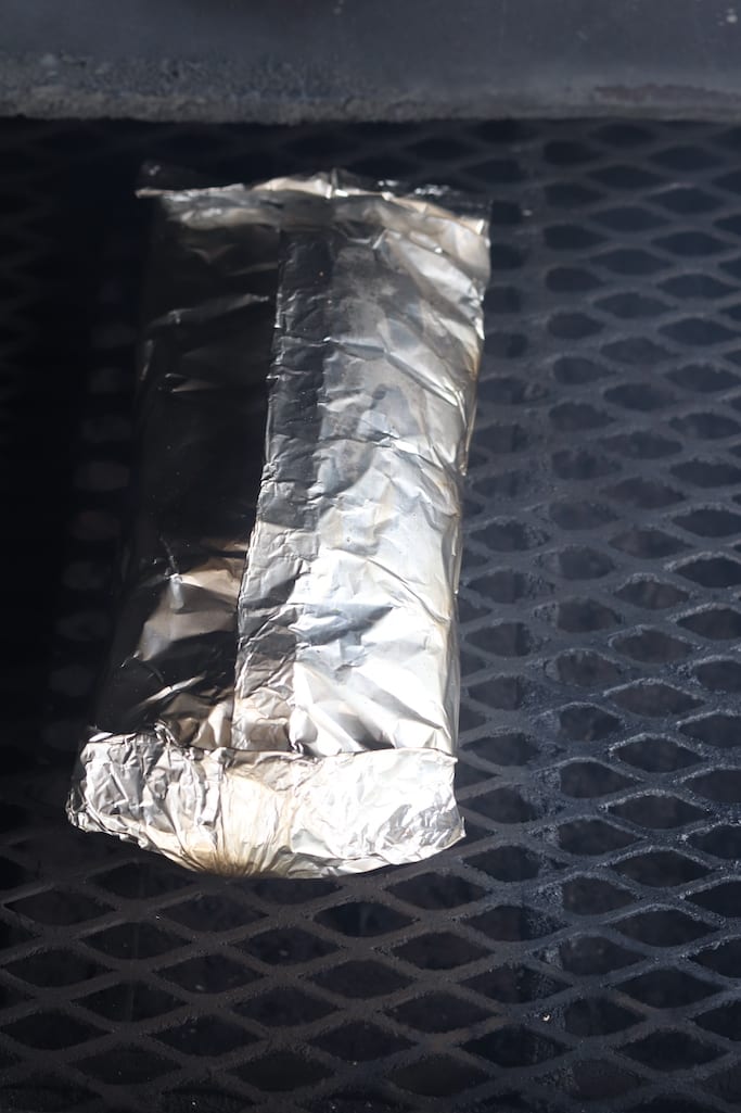 Foil packet of potatoes on a grill