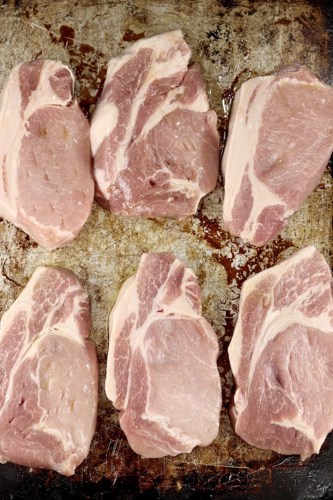 6 boneless pork chops on a sheet pan for grilling