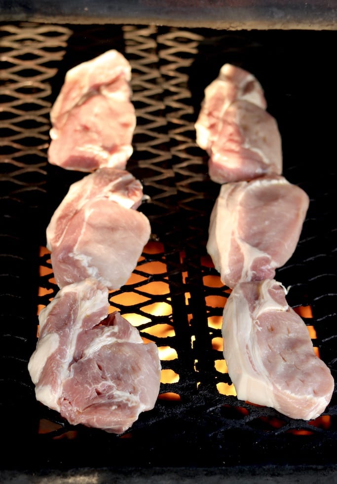 Boneless pork chops on the grill over open fire for pineapple pork chops