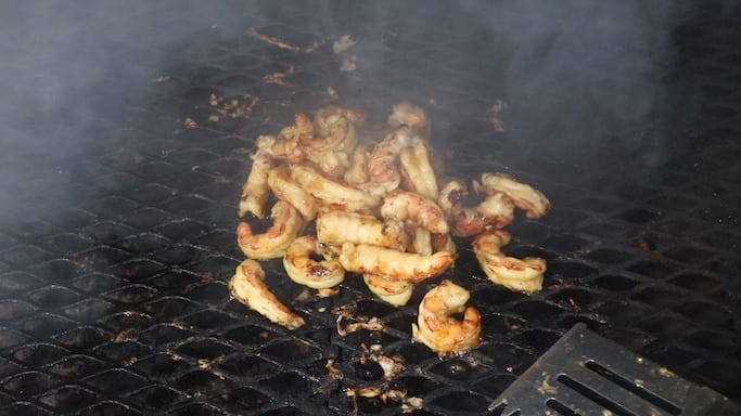 Grilling pineapple shrimp with hickory smoke