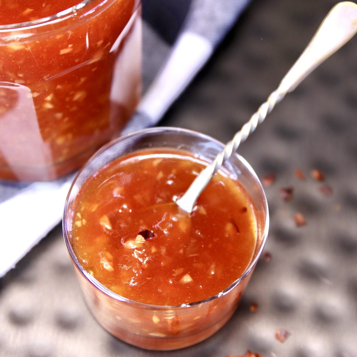 Pineapple BBQ Sauce in a small jar with a spoon.