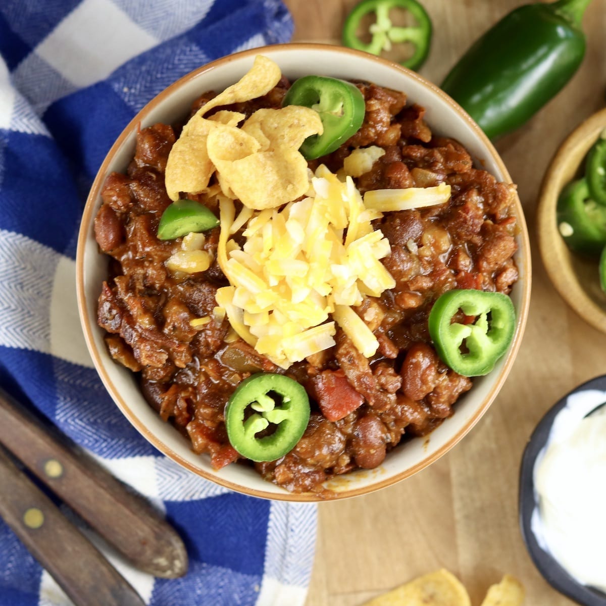 Short Rib Chili with beans, topped with cheese and jalapenos overhead view