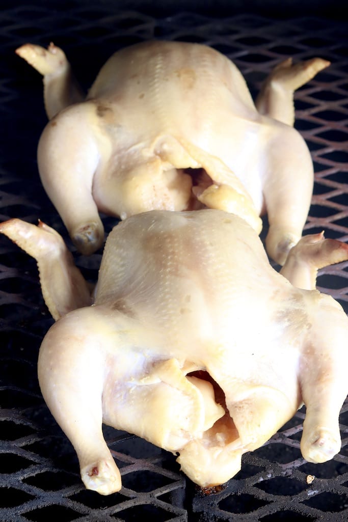 whole chickens on a grill