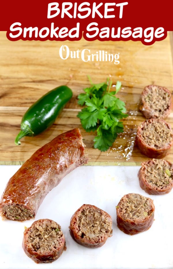 Brisket Smoked Sausage, link and slices with parsley and jalapeno on cutting board - text overlay