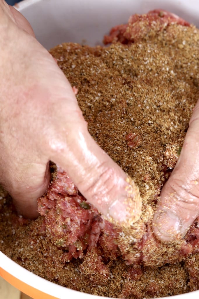 Mixing ground beef with spices for sausage