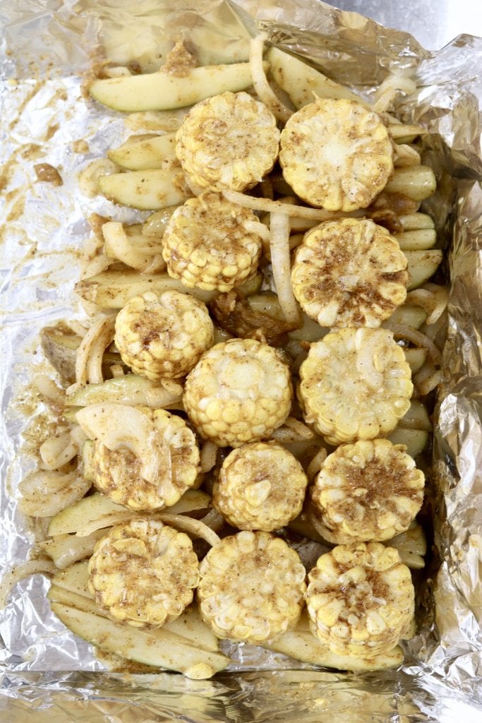 Corn, potatoes and onions in a foil packet with butter and seaonings