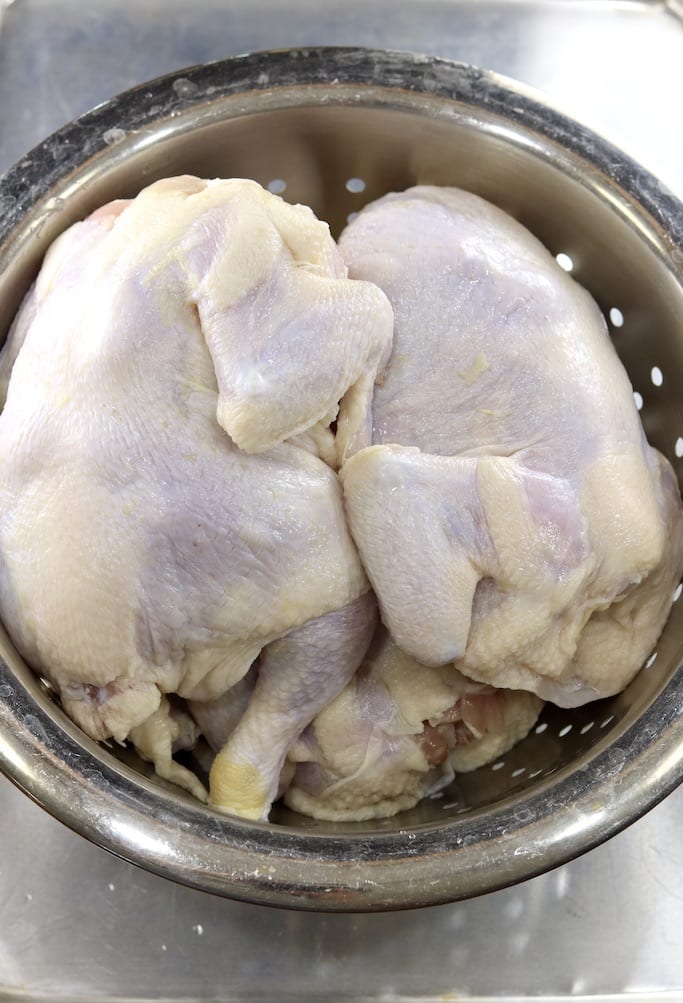 whole chickens in a colander