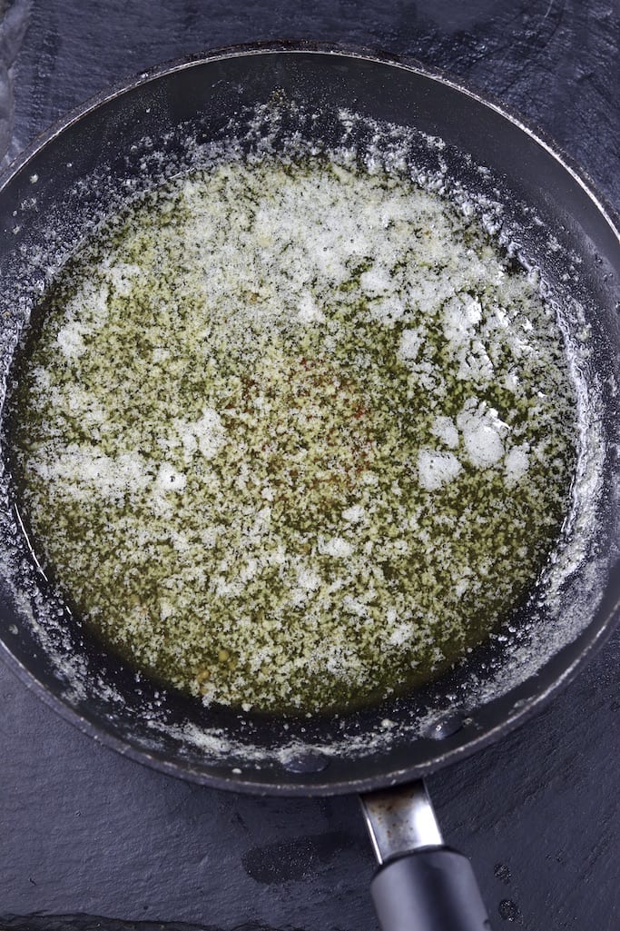 Garlic rosemary butter for grilled chicken in a skillet