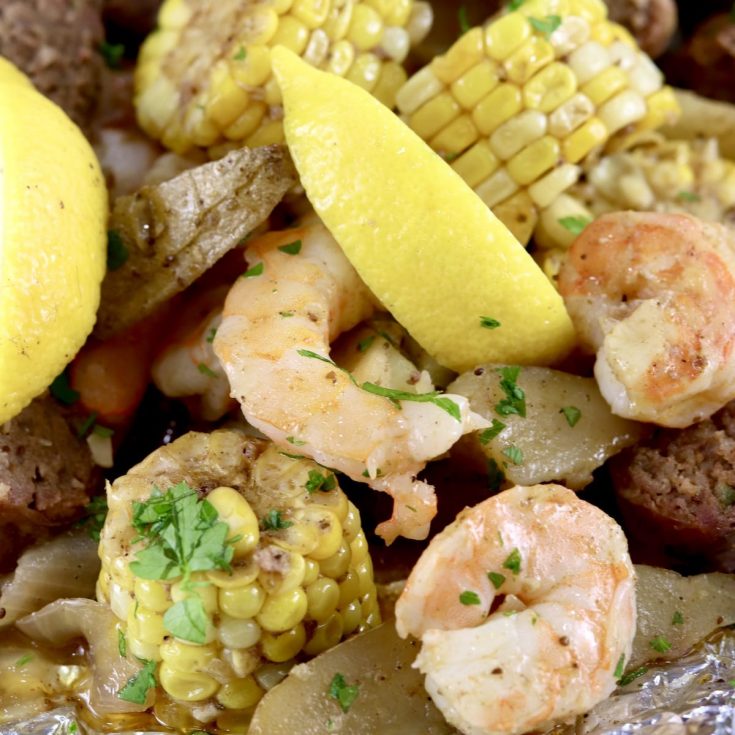 Shrimp Boil made in a foil packet with corn on the cob, potatoes, onions, smoked sausage, lemon