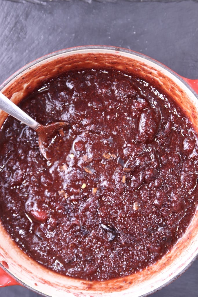 Cranberry BBQ Sauce in a pan with chili flakes on top