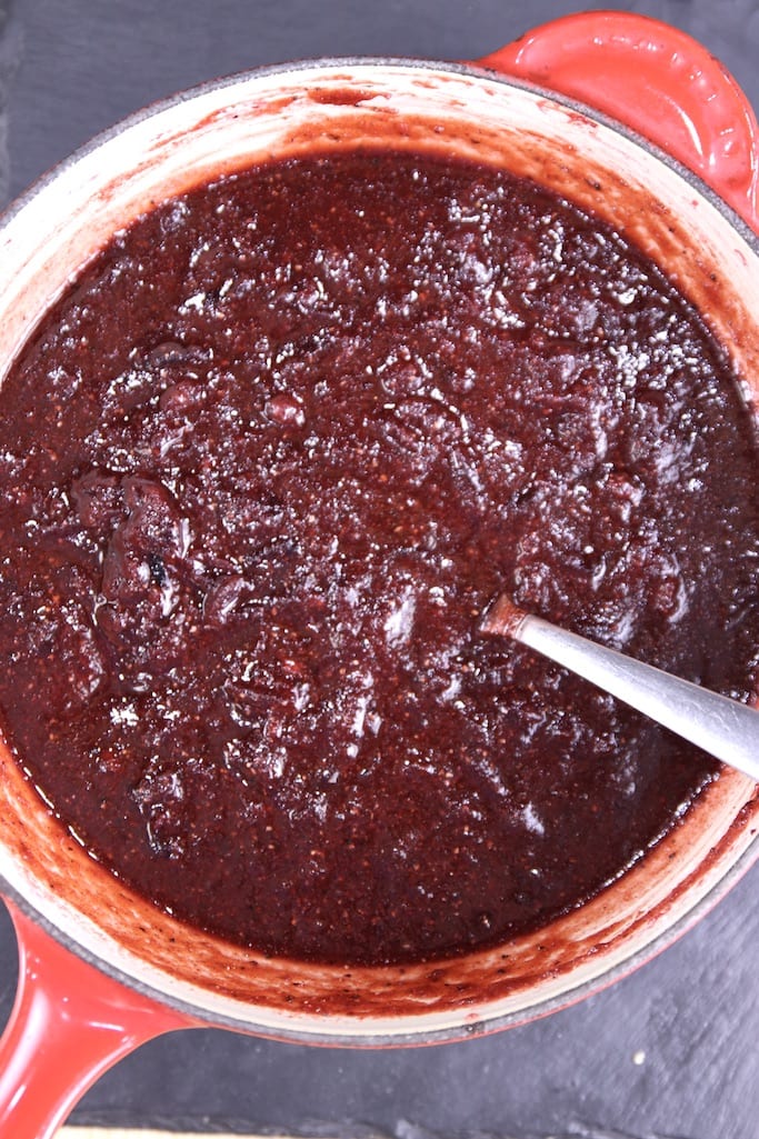 Cranberry BBQ Sauce in a sauce pan with a spoon