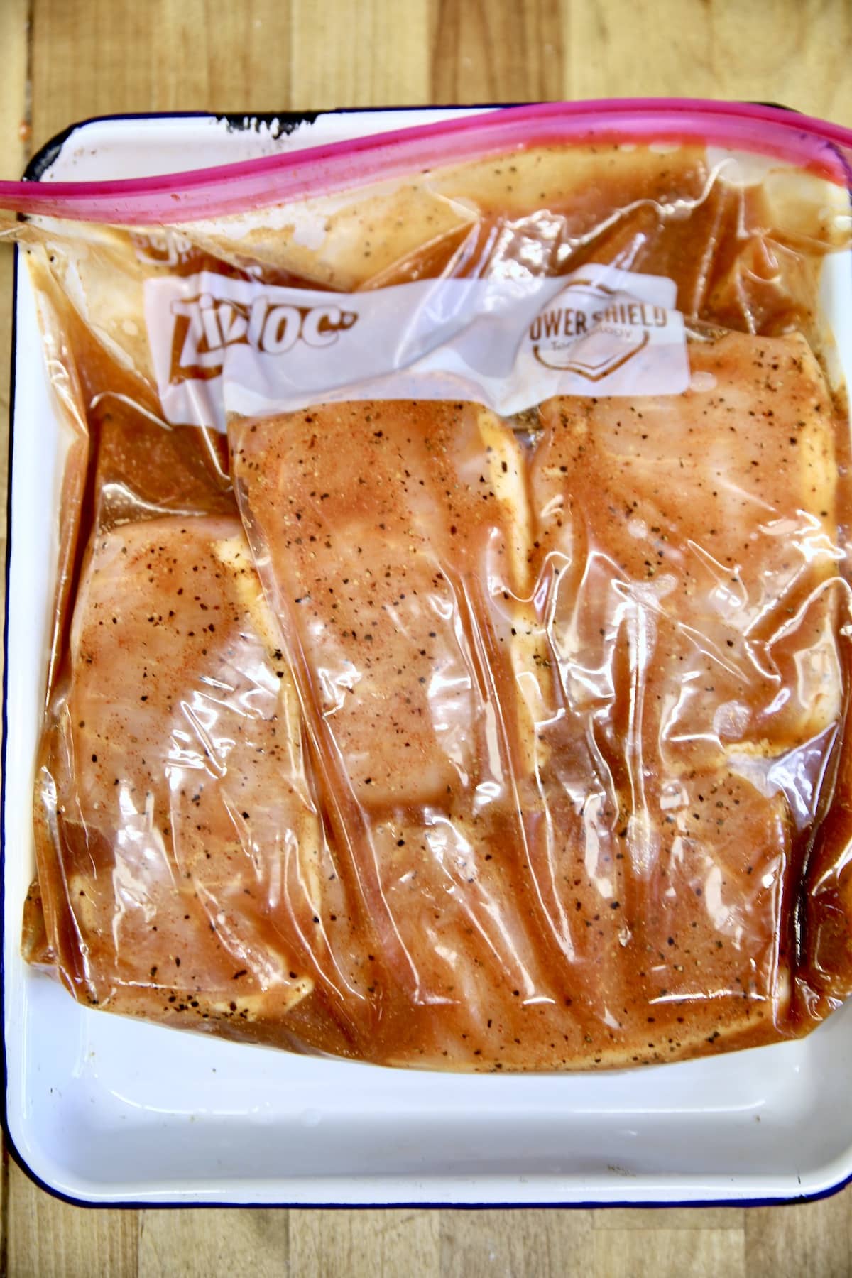 Marinating boneless pork chops in a ziploc bag.