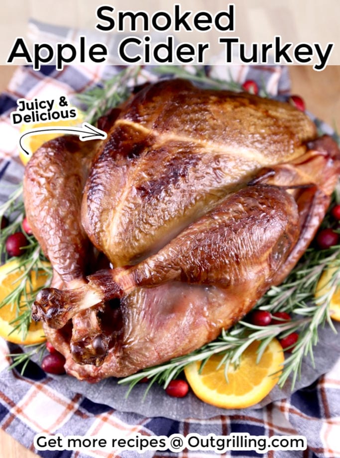Smoked Apple Cider turkey garnished with orange slices, cranberries and rosemary. text overlay of title 