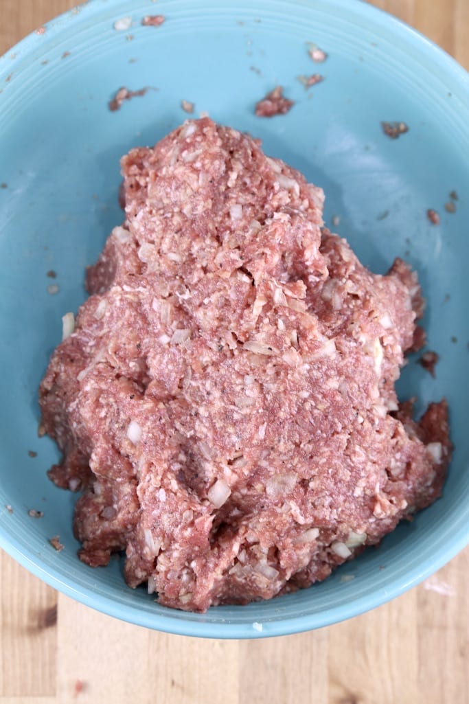 ground beef meatball mixture in a blue bowl