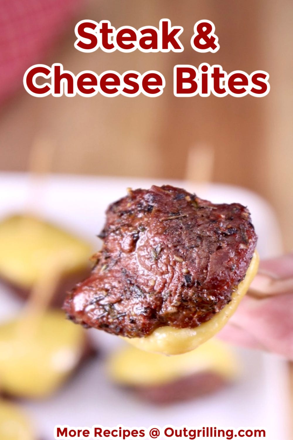 Steak and Cheese Bite appetizers served on a toothpick - closeup view with text overlay