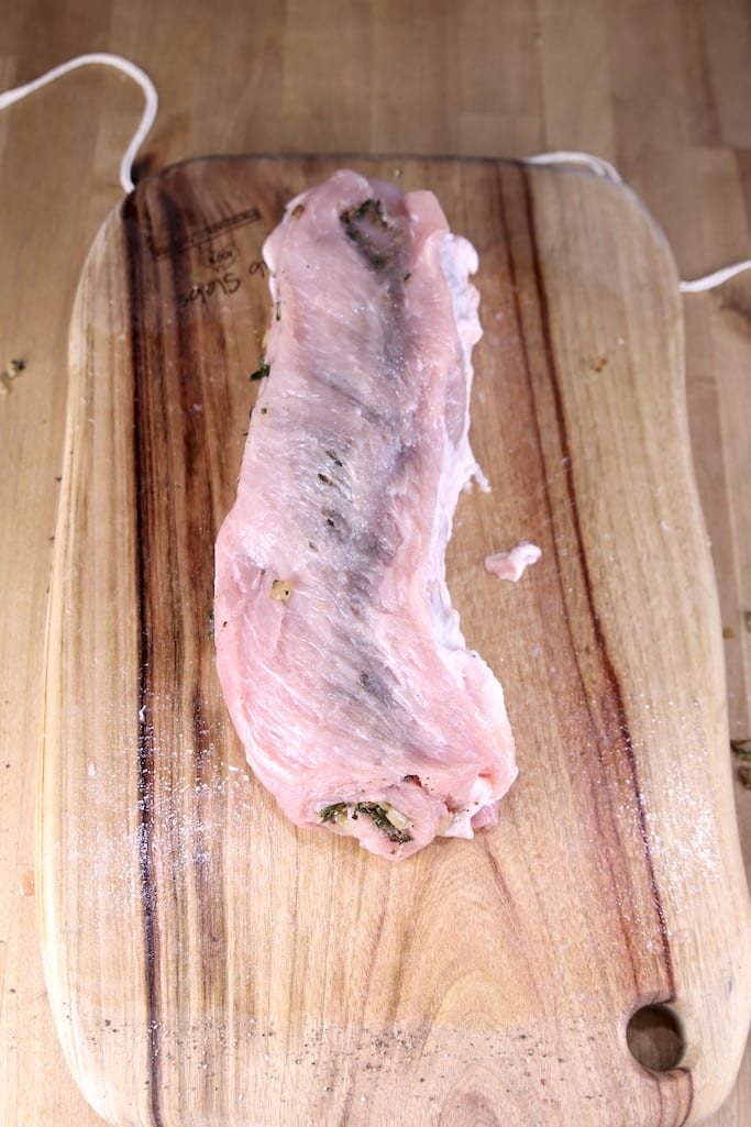 Stuffed Pork Tenderloin on a cutting board (uncooked)