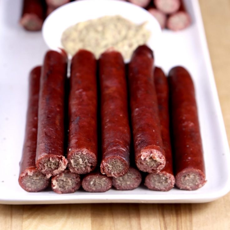 Venison Snack Sticks on a plate with mustard