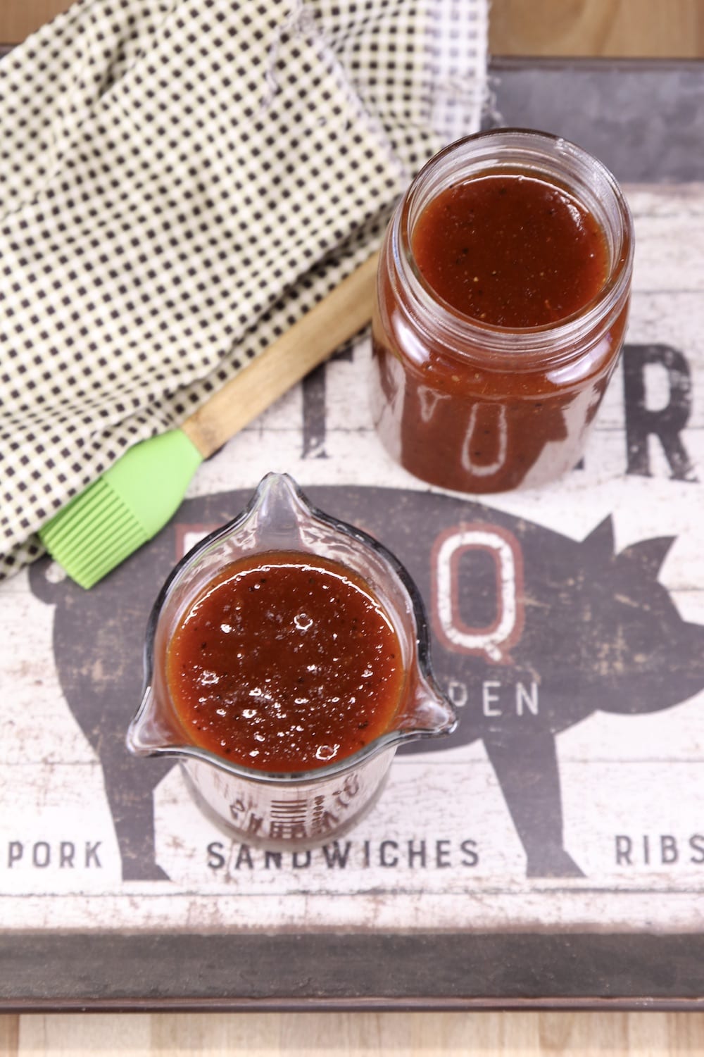 overhead view of 2 jars of bbq sauce on a platter