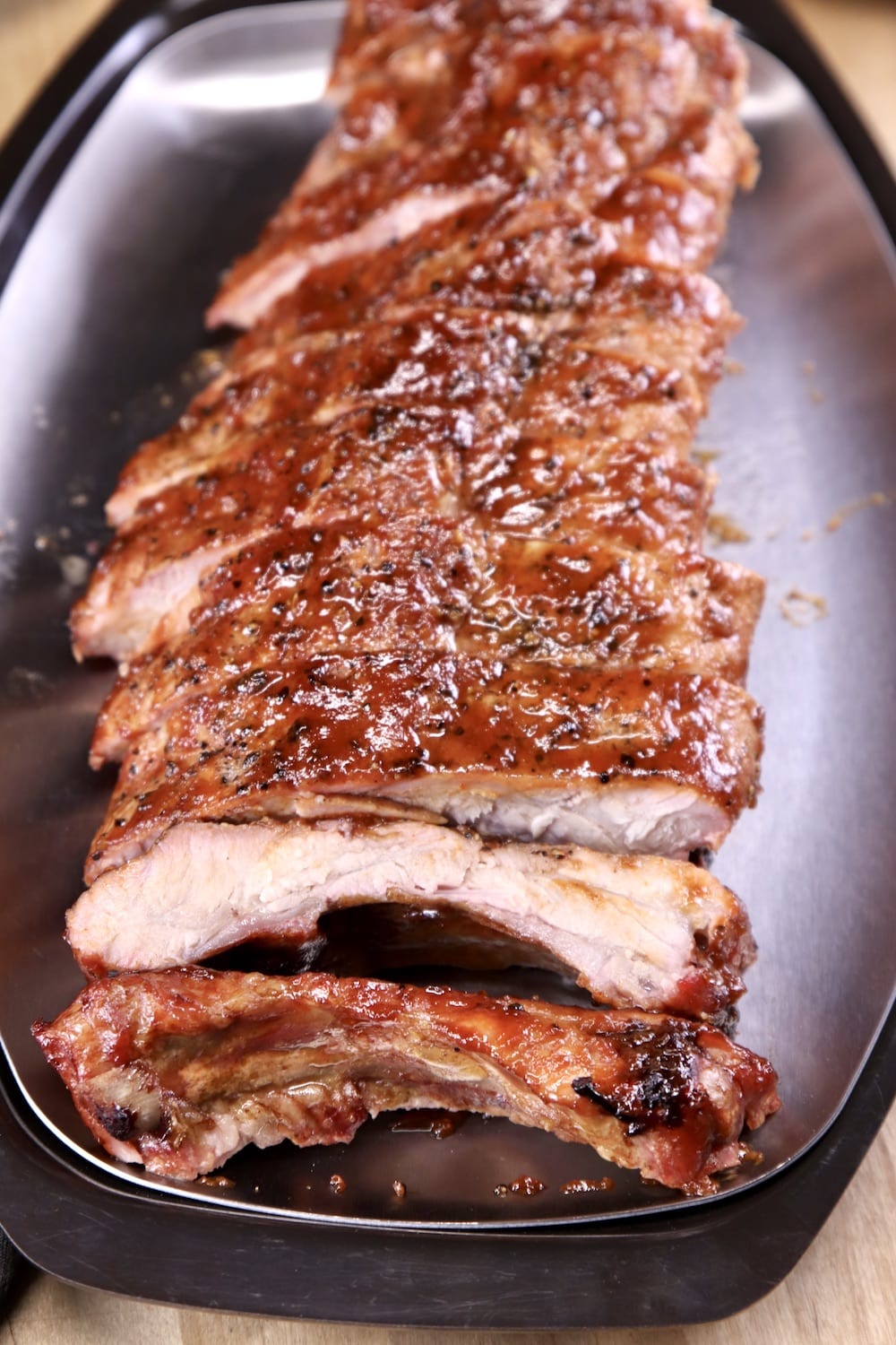 platter of grilled ribs with maple bbq sauce