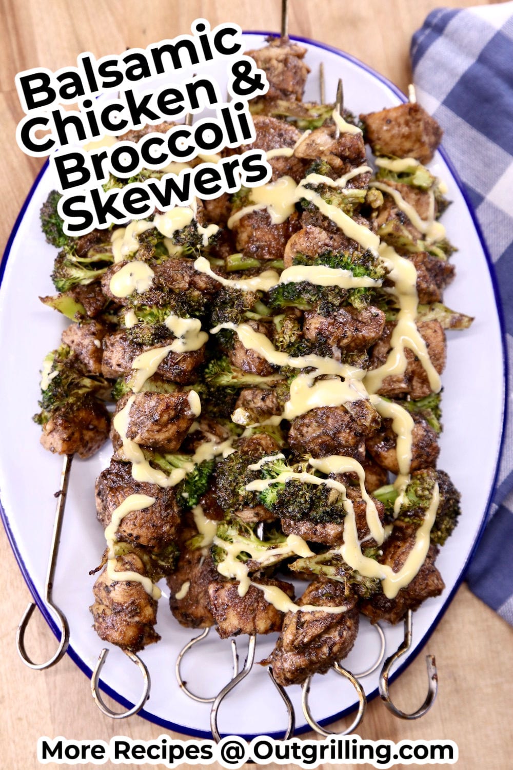 Chicken Broccoli Skewers drizzled with cheese sauce on a platter - text overlay