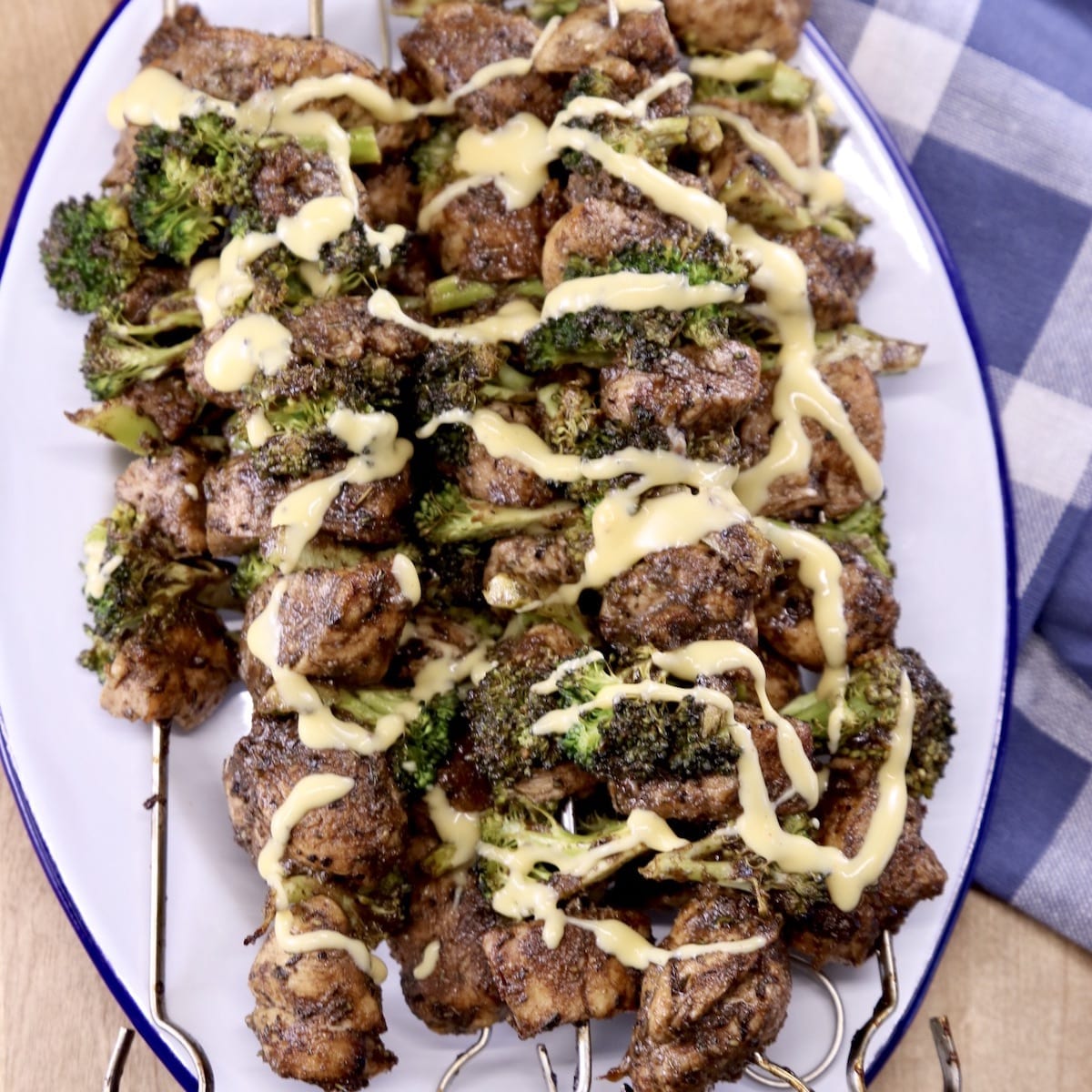 Chicken and Broccoli Skewers with cheese drizzle