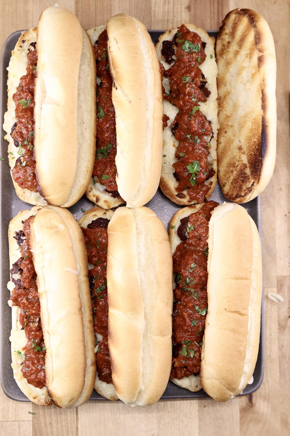 Toasted marinara meatball sub sandwiches - 6 on a platter, top bun off of one