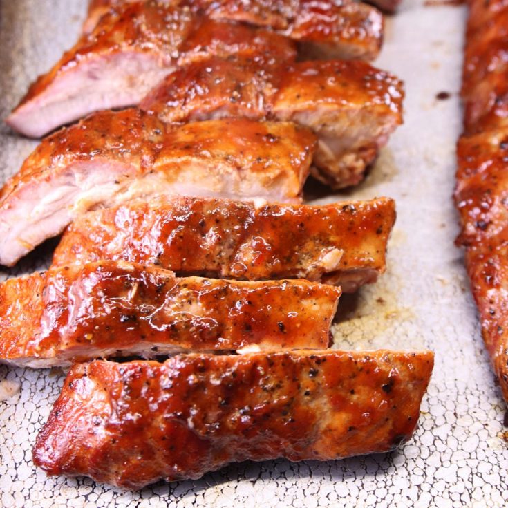 Maple BBQ Baby Back Ribs sliced on a baking sheet